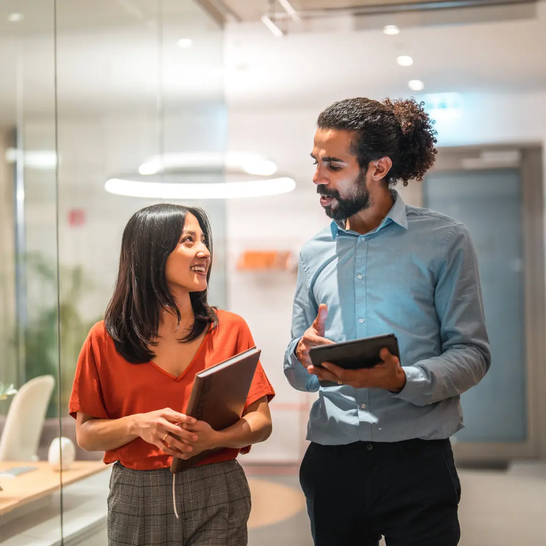 a man and a woman walking together in a corridor